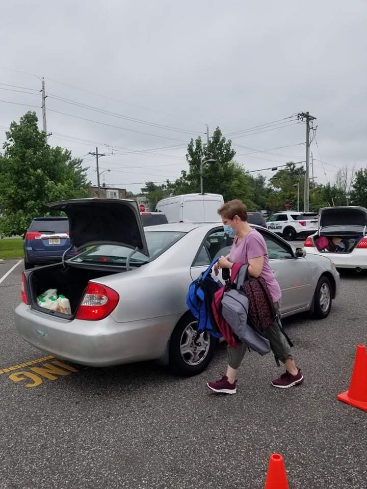 Derry Holland Packs Trunk With Backpacks