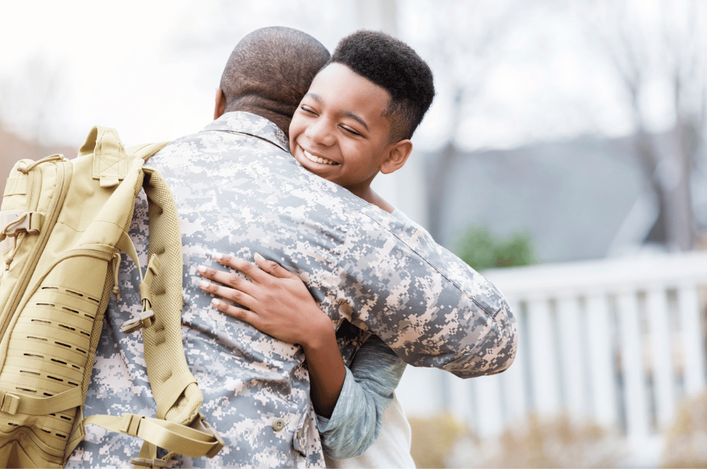 Son hugging military father