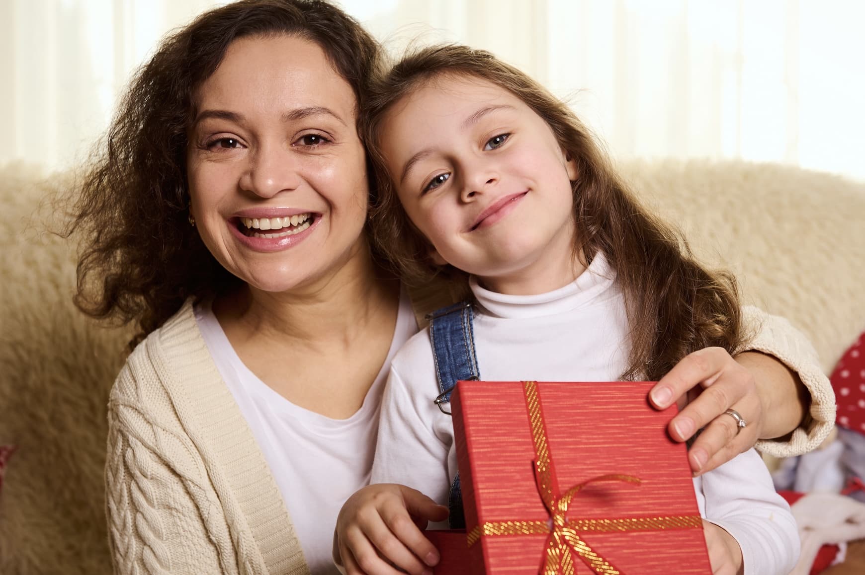 mom and young daughter with holiday gift